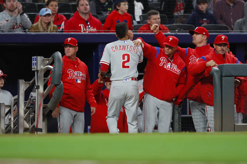 Philadelphia Phillies shortstop J.P. Crawford (2) celebrates with teammates after scoring in the eleventh inning of a baseball game against the Atlanta Braves, Friday, March 30, 2018, in Atlanta. ...