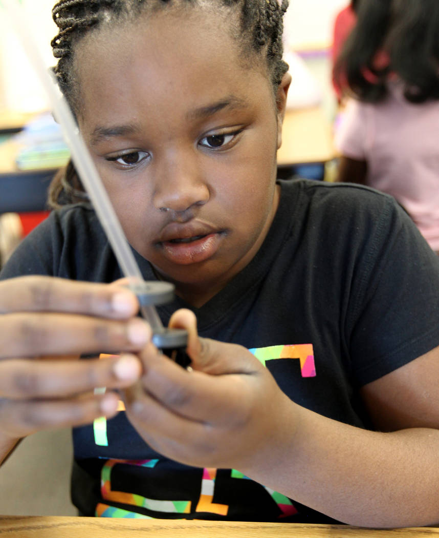 Booker Elementary School student Iyanais Vincent makes magnets float in class, Wednesday, April 4, 2018. Booker is a Prime 6 school, part of Clark County School District's desegregation initiative ...