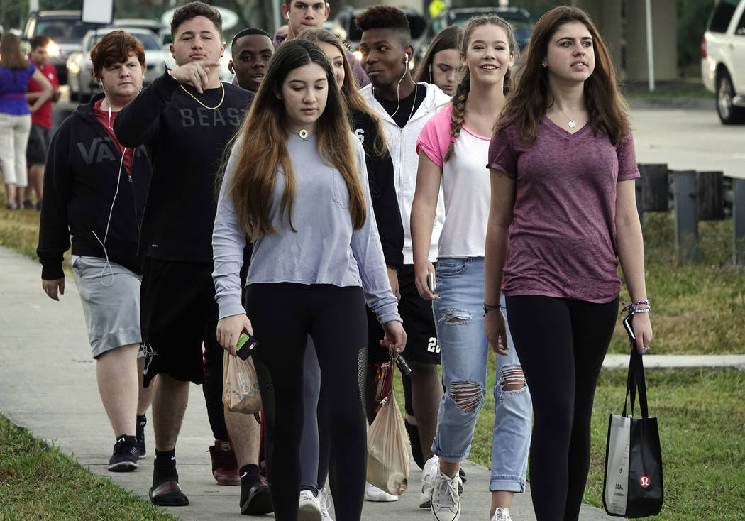 Marjory Stoneman Douglas High School students arrive back to school after spring break without backpacks, Monday, April 2, 2018, in Parkland, Fla. Students at the Florida high school where 17 peop ...
