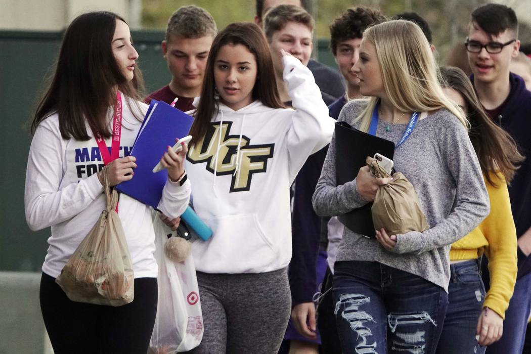 Marjory Stoneman Douglas High School students arrive back to school after spring break without backpacks, Monday, April 2, 2018, in Parkland, Fla. Students at the Florida high school where 17 peop ...