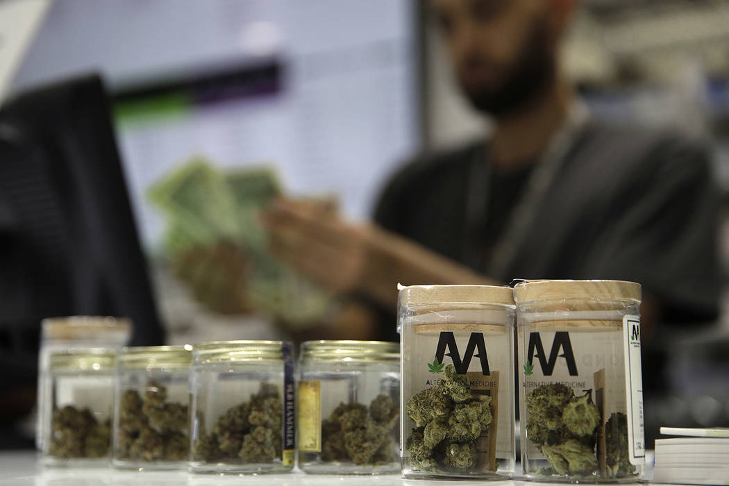 A cashier rings up a marijuana sale at the Essence cannabis dispensary in Las Vegas in July 2017. (AP Photo/John Locher)