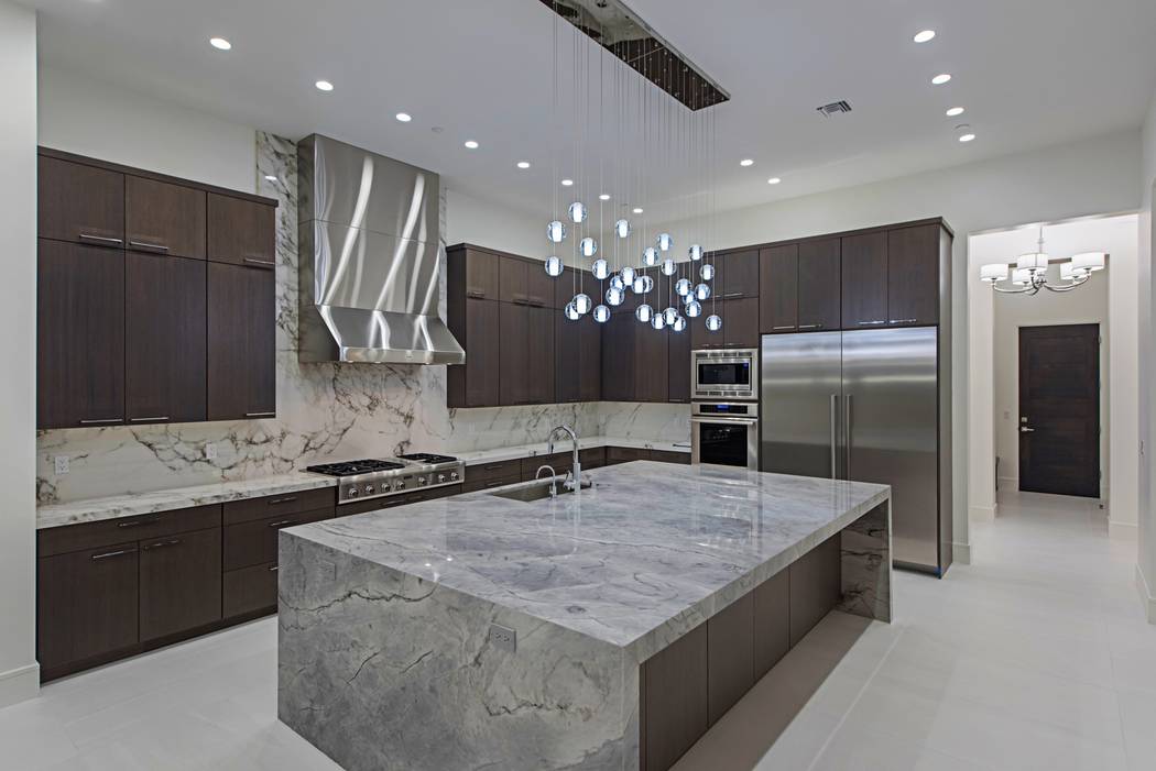 Canyon Creek Custom Homes
The kitchen has upgraded appliances and a waterfall island.