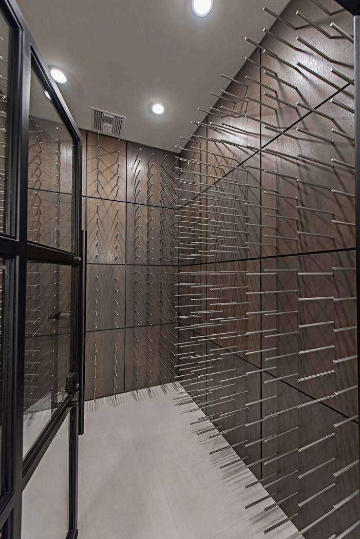 The wine room has stainless-steel pegs and can hold 750 bottles. (Canyon Creek Custom Homes)