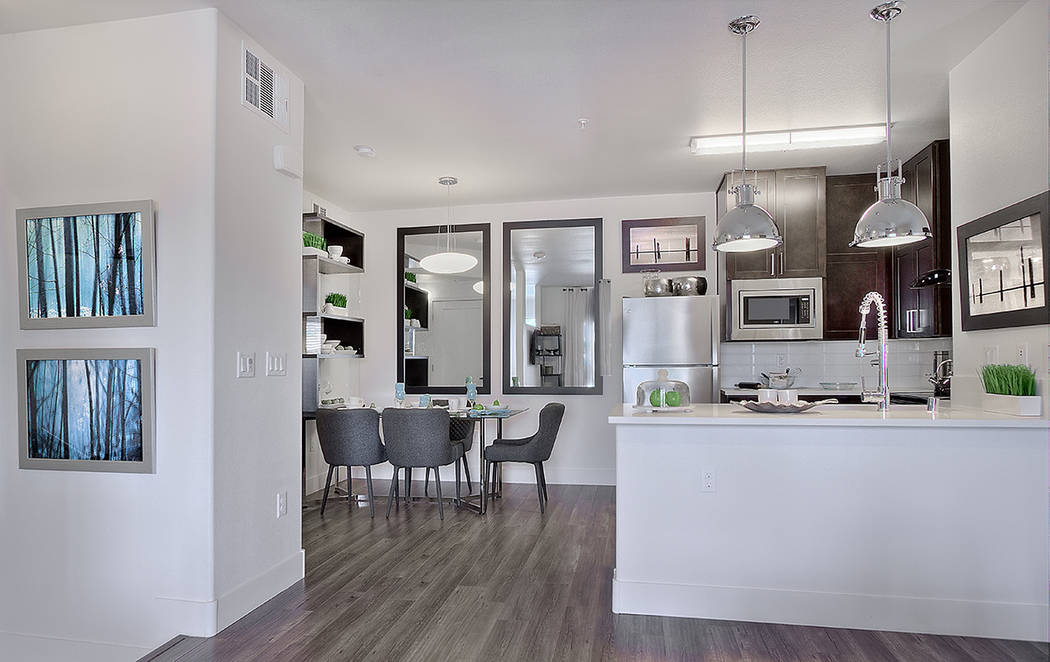 The kitchens have wood laminate flooring, dark wood kitchen cabinetry and quartz countertops. (WestCorp Management Group)