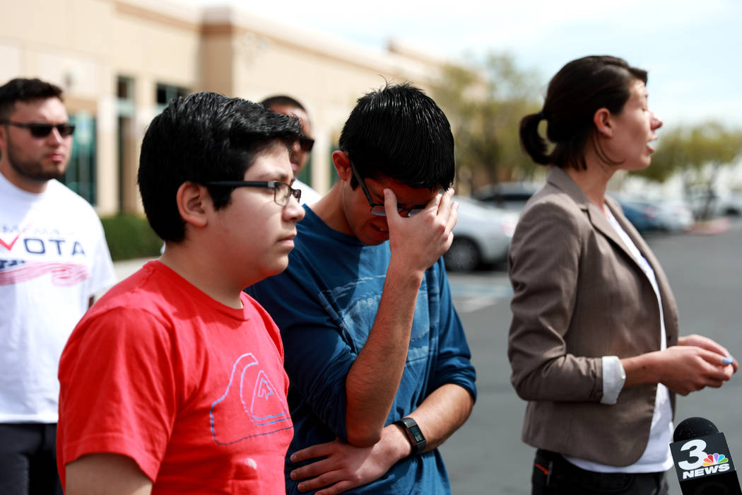Eric Avelar-Gomez, 13, and his brother Ricardo, 18, stand next to Bliss Requa-Trautz as she talks about their mother,  who was detained by Immigration and Customs Enforcement when she showed up to ...