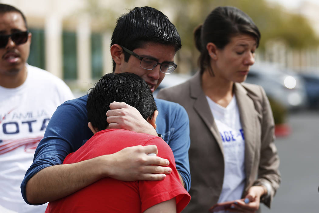 Ricardo Avelar-Gomez, 18, embraces his brother Eric, 13, after talking about their mother, who was detained by Immigration and Customs Enforcement when she showed up to an appointment regarding le ...