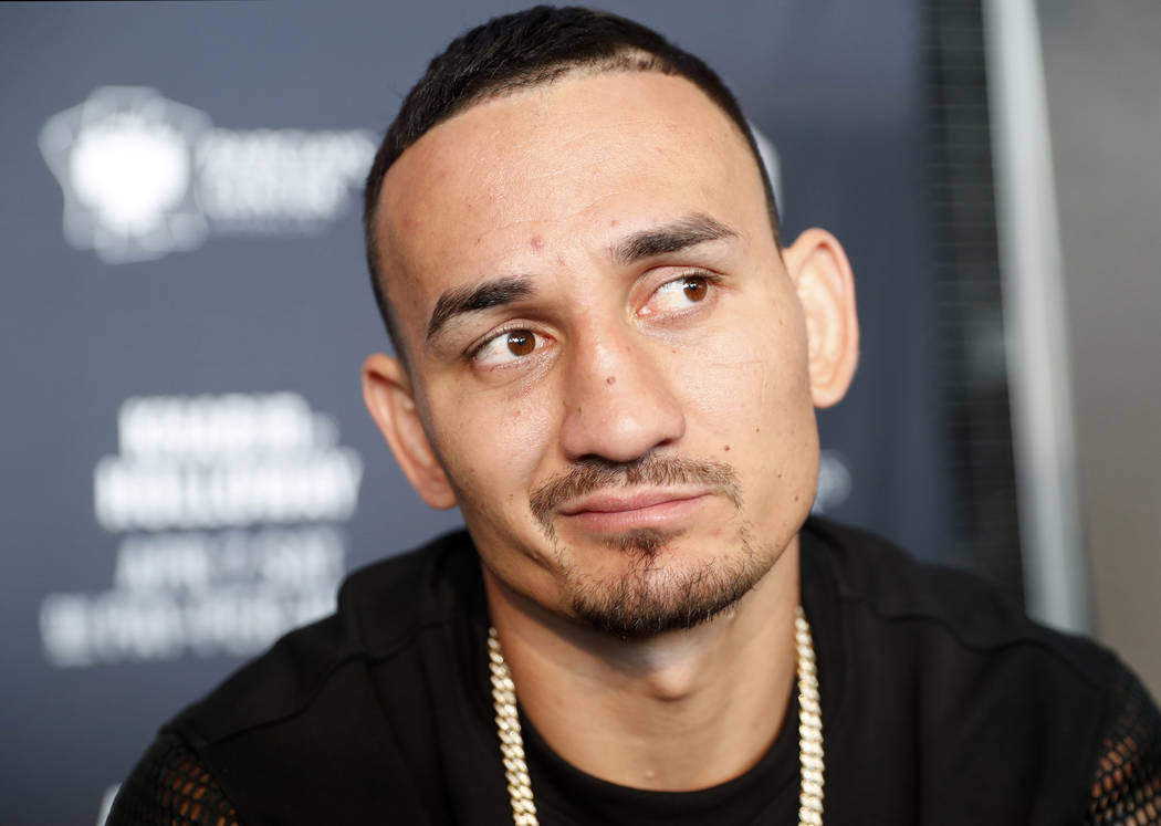 UFC featherweight champion Max Holloway ponders a reporter's question during UFC223's media event, Thursday, April 5, 2018, in New York, ahead of his UFC lightweight title fight against Max Nurmam ...