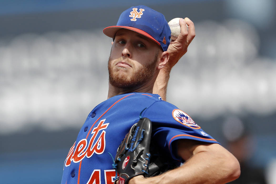 In this March 7, 2018, file photo, New York Mets starting pitcher Zack Wheeler warms up before the first inning of a spring training baseball game against the New York Yankees in Port St. Lucie, F ...