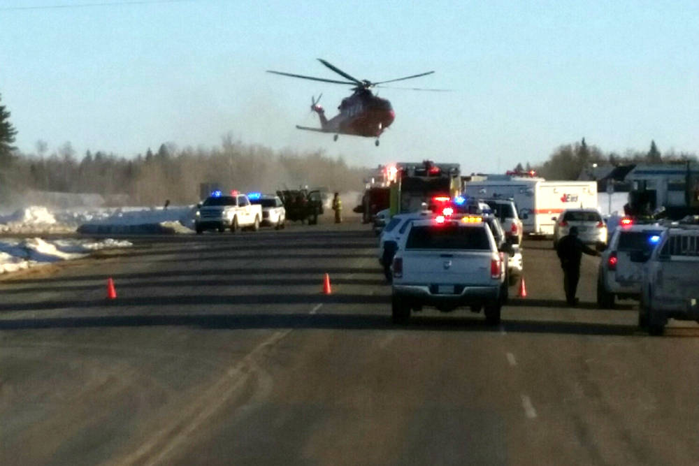 This image provided by 650 CKOM/980 CJME shows emergency crews responding to the scene where a bus carrying a junior hockey team to a playoff game was struck by a semi Friday, April 6, 2018, north ...
