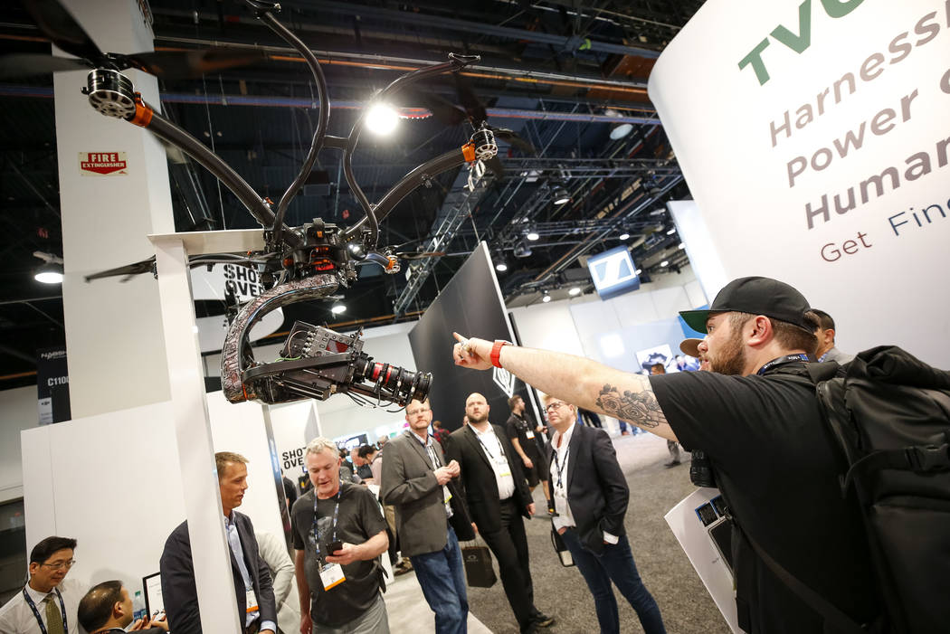A show attendee browses over Shotover's U1, a professional-grade unmanned aerial vehicle for broadcast, motion picture, surveillance and industrial survey markets, during the NAB Show at the Las V ...