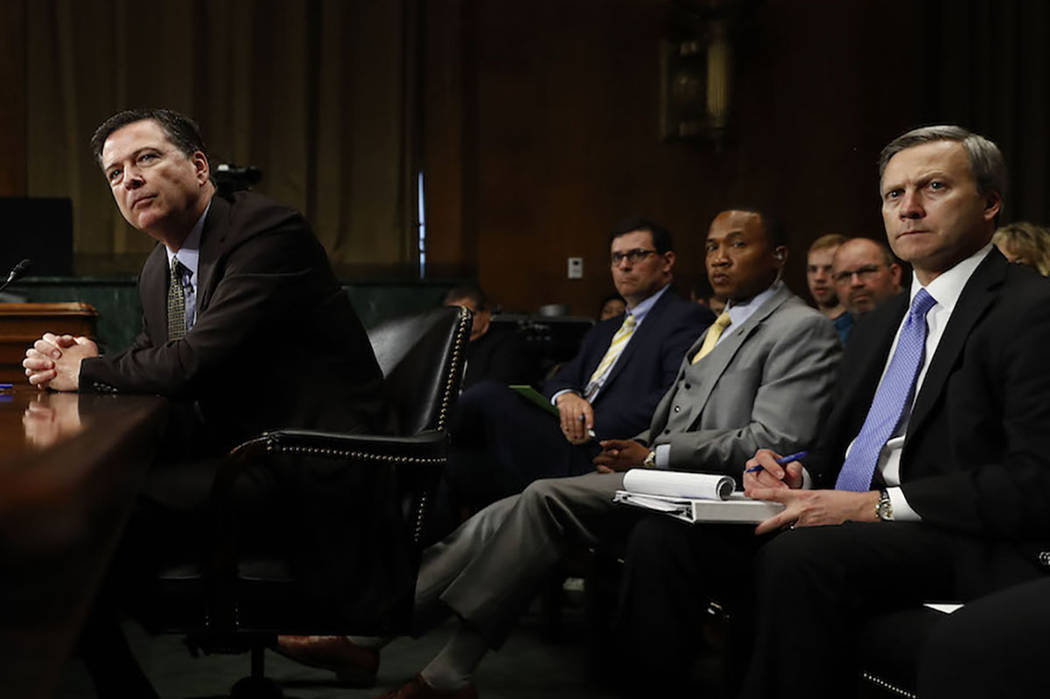 FBI Director James Comey pauses as he testifies on Capitol Hill in Washington, Wednesday, May 3, 2017, before the Senate Judiciary Committee hearing. Behind him, right, is Assistant FBI Director G ...