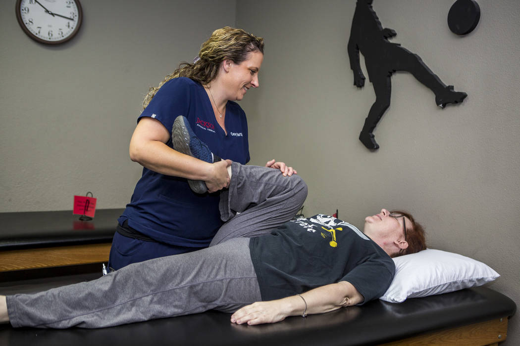 Casey Bartolo, P.T., who worked with several survivors of the Oct. 1 shooting for free, helps