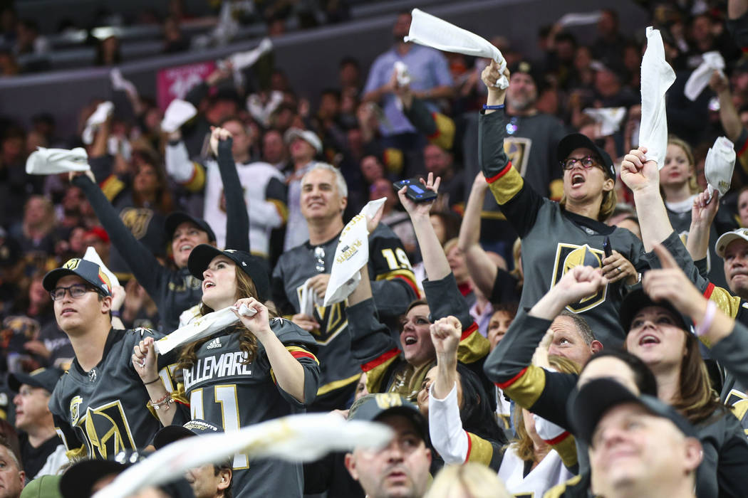 Golden Knights fans cheer during the third period of Game 1 of an NHL hockey first-round playoff series against the Los Angeles Kings at T-Mobile Arena in Las Vegas on Wednesday, April 11, 2018. C ...