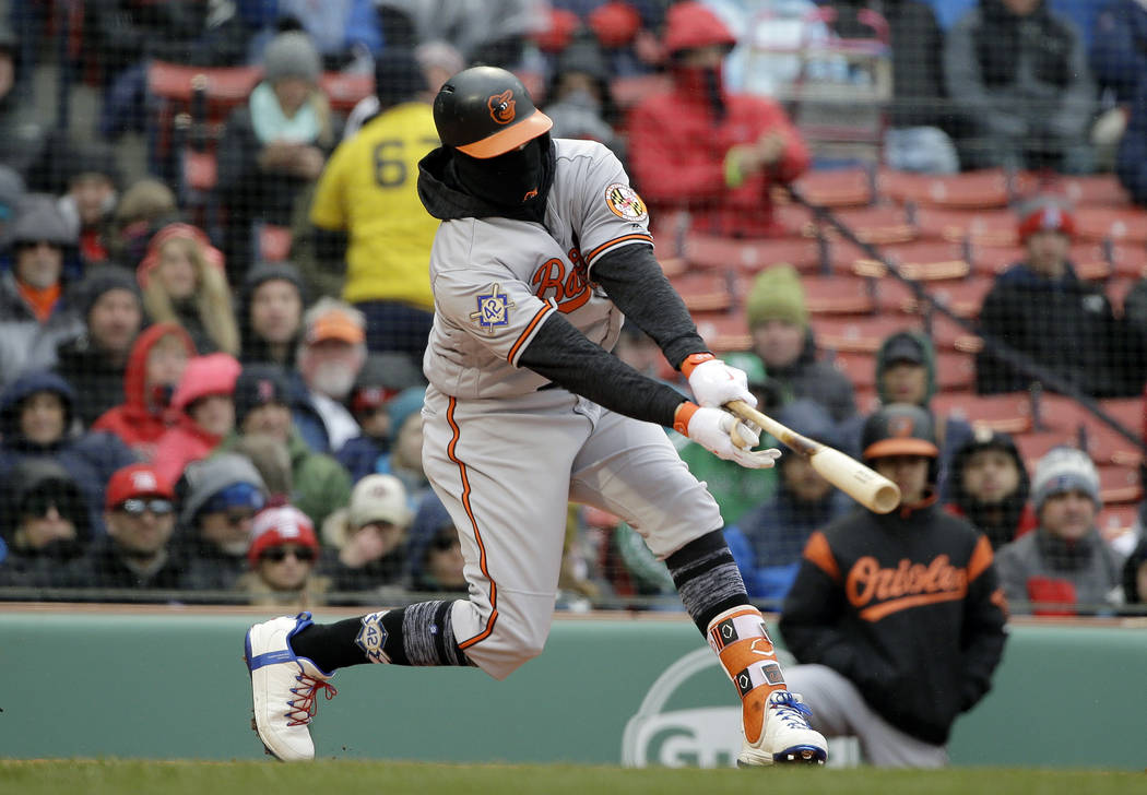 Baltimore Orioles' Manny Machado hits an RBI-double off a pitch by Boston Red Sox's Chris Sale in the first inning of a baseball game Sunday, April 15, 2018, in Boston. (AP Photo/Steven Senne)