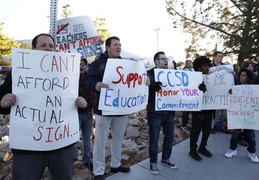 Teachers, including Matt Nighswonger, second left, protest outside Shadow Ridge High School on Tuesday, April 17, 2018, in Las Vegas. Bizuayehu Tesfaye/Las Vegas Review-Journal @bizutesfaye