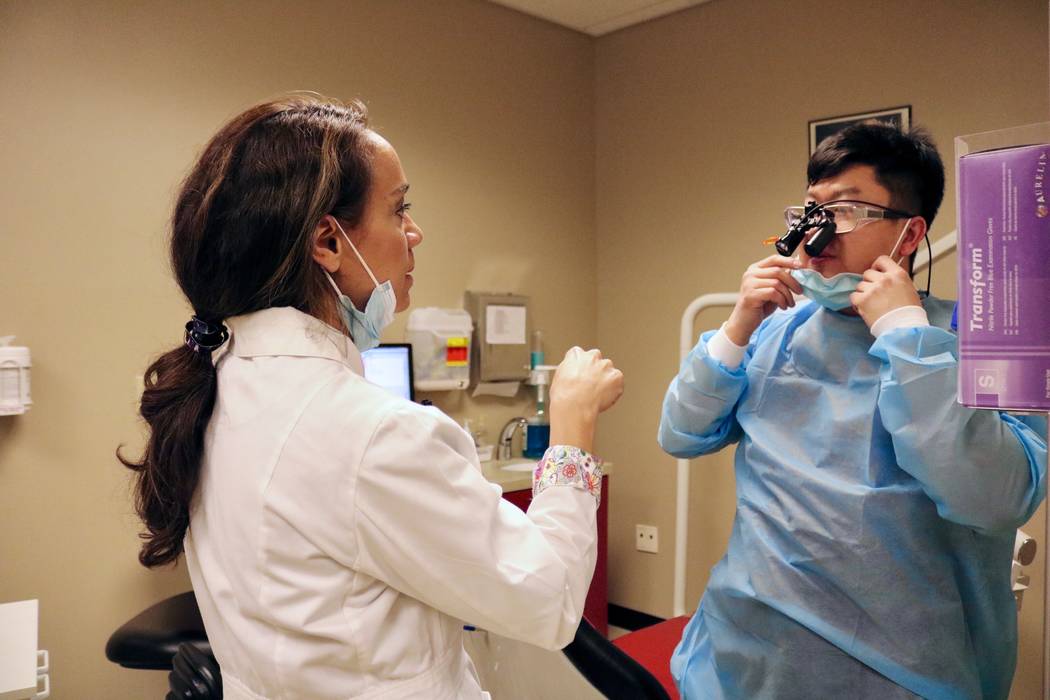 Dr. Tina Brandon Abbatangelo speaks with fourth-year dental student Raymond Yang at the Maryland Campus Dental Clinic on the UNLV campus in Las Vegas on Tuesday, April 17, 2018. Abbatangelo is a h ...