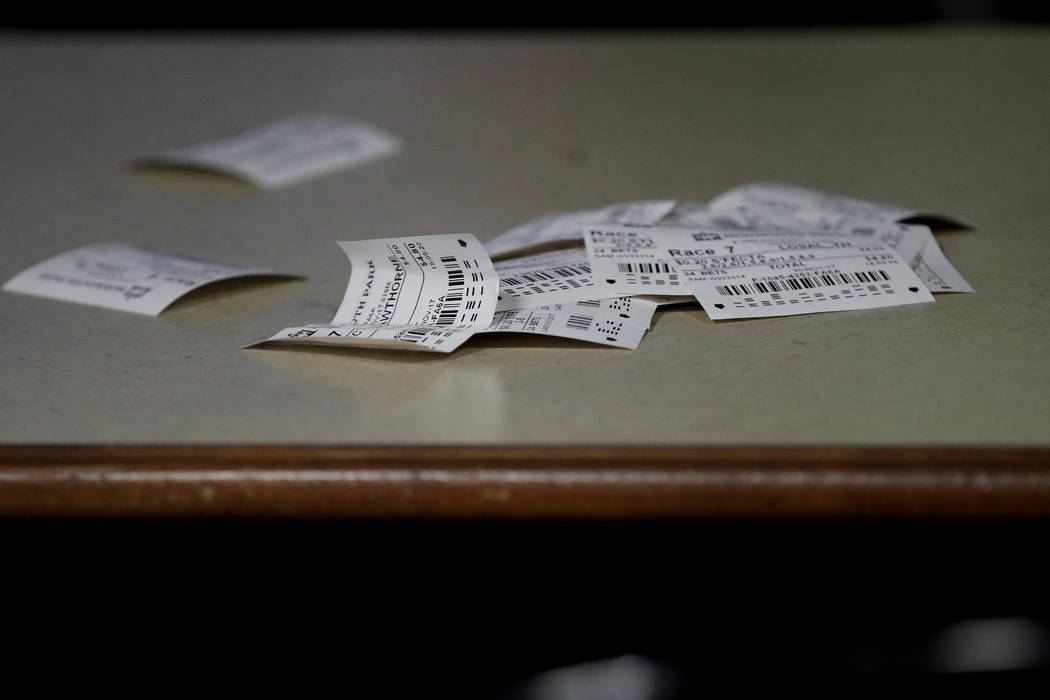 In this Nov. 30, 2017, photo, betting slips are seen on a table at the Monmouth Park racetrack in West Long Branch, N.J. With banks of TVs tuned to all-sports stations and a spacious bar, the loun ...