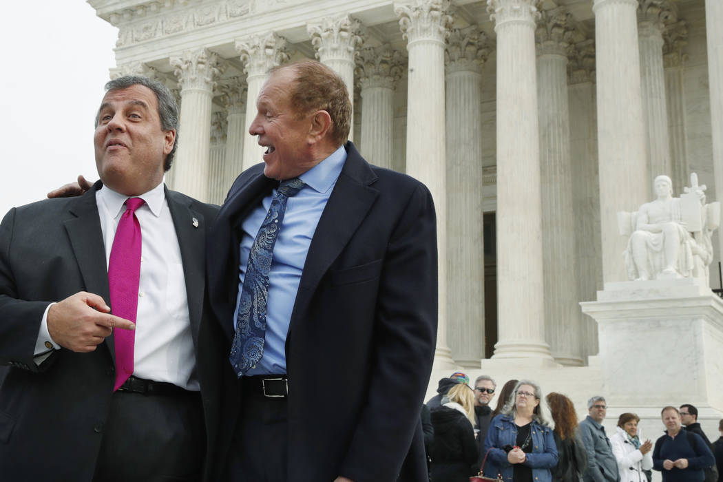 New Jersey Gov. Chris Christie, left, and New Jersey State Sen. Raymond Lesniak, talk after a news conference at the Supreme Court where a case on sports betting is being heard, Monday, Dec. 4, 20 ...
