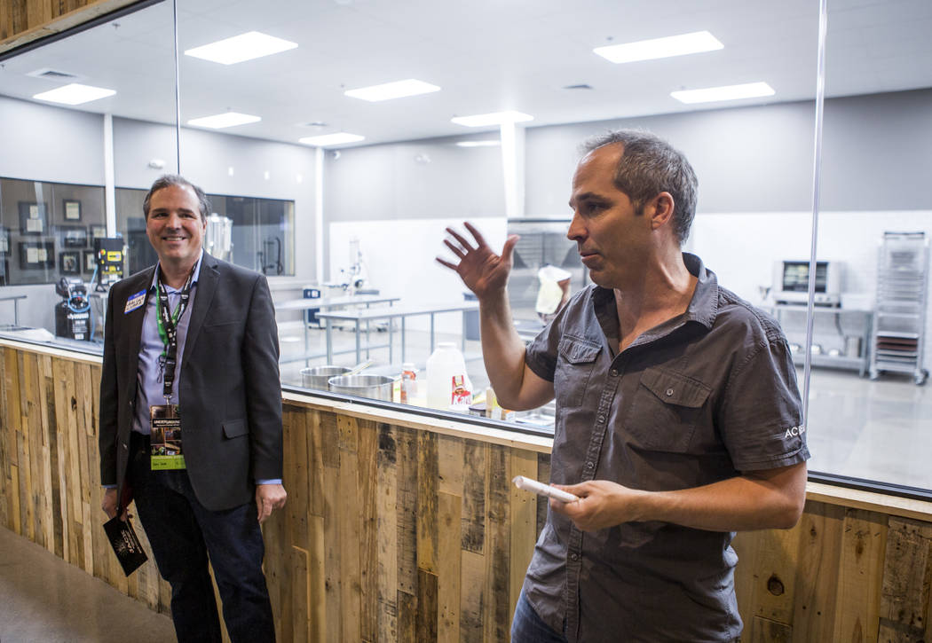 John Mueller, founder and CEO of Acres Dispensary, talks about the dispensary's new cannabis kitchen while John Laub, president of the Las Vegas Medical Marijuana Association, listens in the backg ...