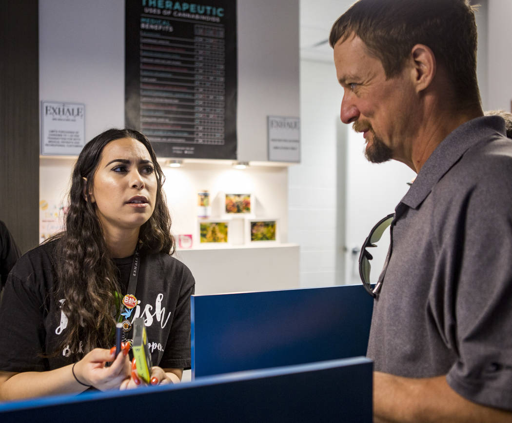 Alyssa Jusino helps Michael Brousseau of New Mexico pick out a product for vaping at Exhale Nevada on Friday, April 23, 2018. Patrick Connolly Las Vegas Review-Journal @PConnPie