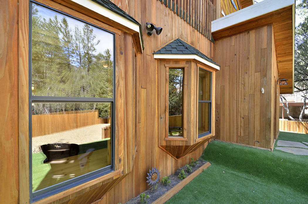 The exterior of the property is covered in a clear redwood siding. (Bill Hughes Real Estate Millions)