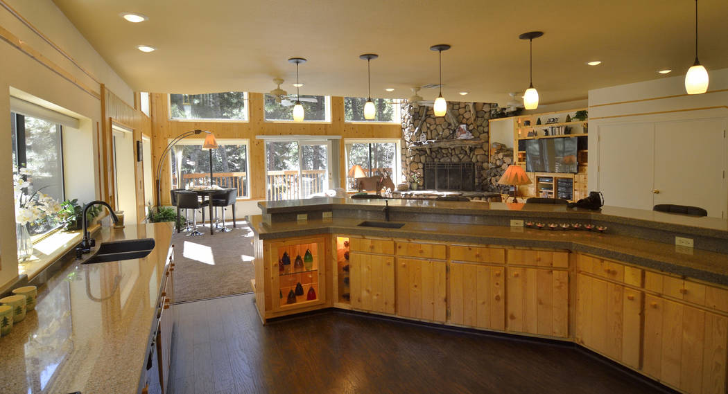 The kitchen's cabinets were made from knotty pine found in the original cabin on the site. (Bill Hughes Real Estate Millions)