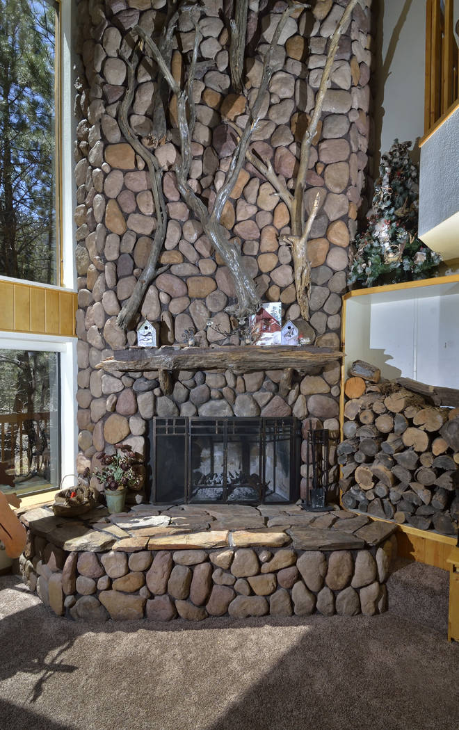 The massive fireplace is a focal point of the home. (Bill Hughes Real Estate Millions)