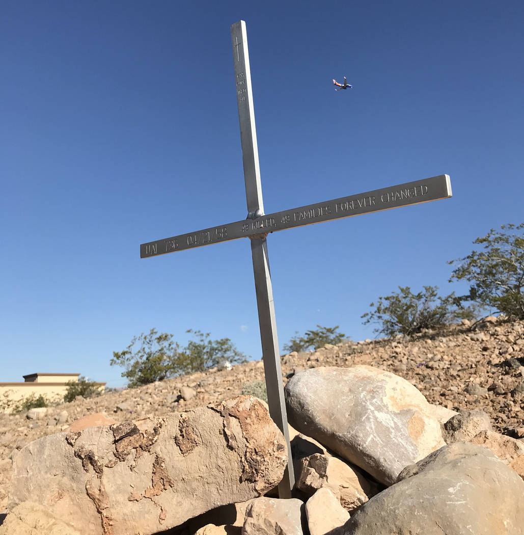 A Southwest Airlines jetliner flies past an engraved cross Friday marking the site of an April 21, 1958, crash that still ranks as the worst air disaster in Las Vegas history. Henry Brean Las Vega ...