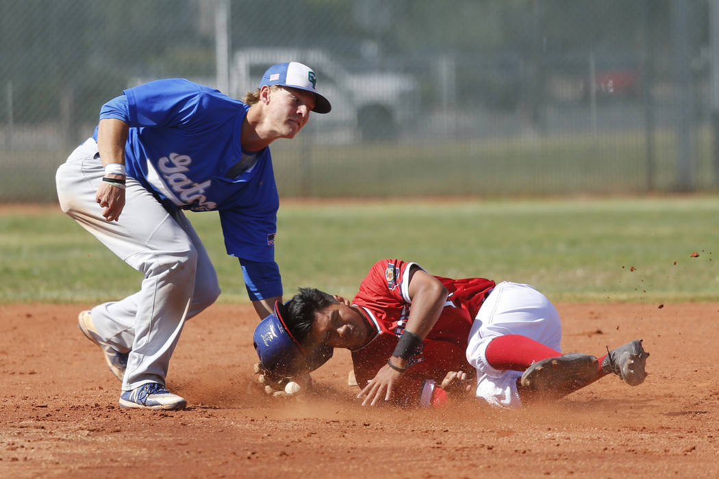 Liberty's Zanden Shim (10) is tagged out by Green Valley's Carter Gehlken (10) at second base during the first inning of the baseball game at Liberty High School in Henderson, Friday, April 20, 20 ...