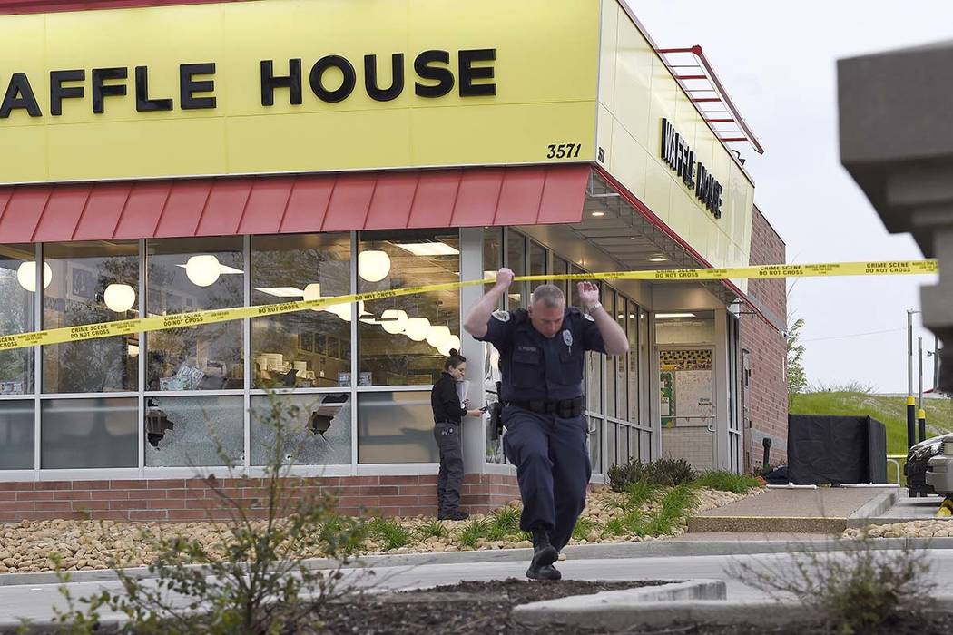 Law enforcement officials work the scene of a fatal shooting at a Waffle House in the Antioch neighborhood of Nashville, Sunday, April 22, 2018. (George Walker IV/The Tennessean via AP)
