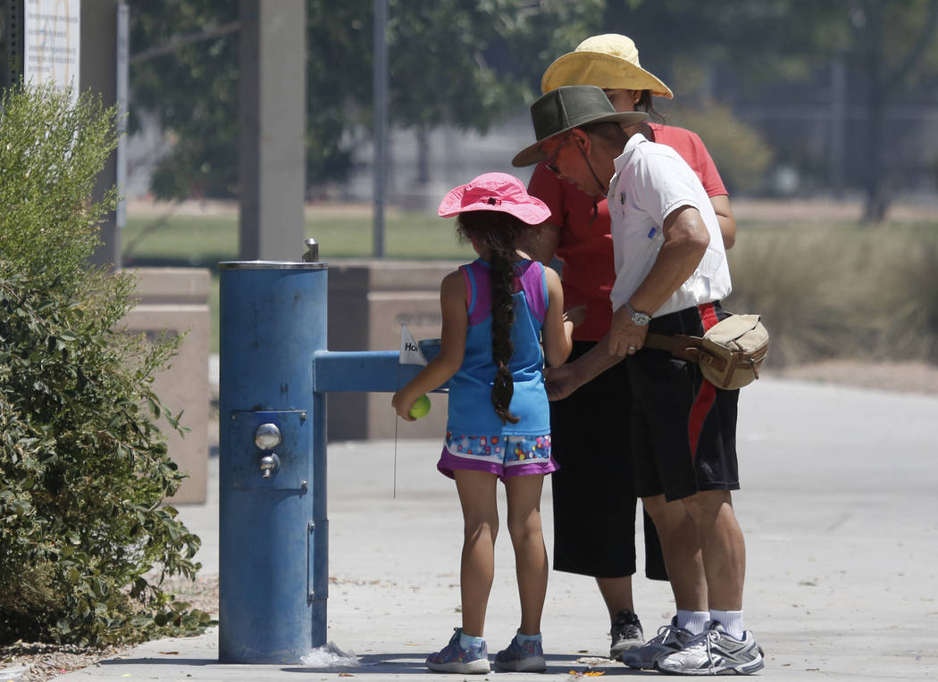 With temperatures starting to climb into the 90s, those who enjoy being outside should stay hydrated and wear head gear like these people seen at Lorenzi Park last May. (Bizuayehu Tesfaye/Las Vega ...