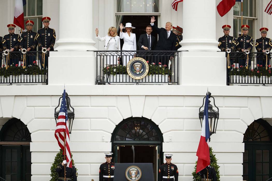 Brigitte Macron, first lady Melania Trump, French President Emmanuel Macron, and President Donald Trump wave during a State Arrival Ceremony on the South Lawn of the White House, Tuesday, April 24 ...