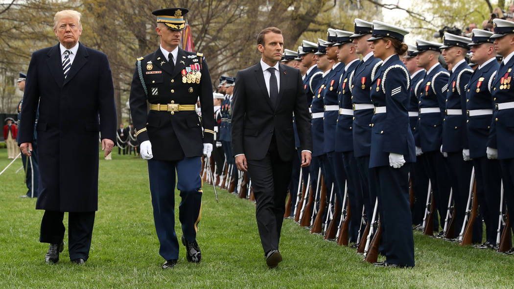 President Donald Trump and French President Emmanuel Macron review the troops during a State Arrival Ceremony on the South Lawn of the White House in Washington, Tuesday, April 24, 2018. (AP Photo ...