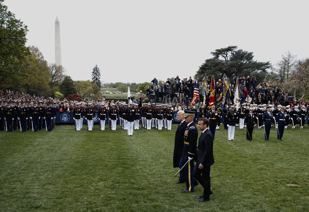 President Donald Trump and French President Emmanuel Macron review troops during a State Arrival Ceremony on the South Lawn of the White House in Washington, Tuesday, April 24, 2018. (AP Photo/Car ...