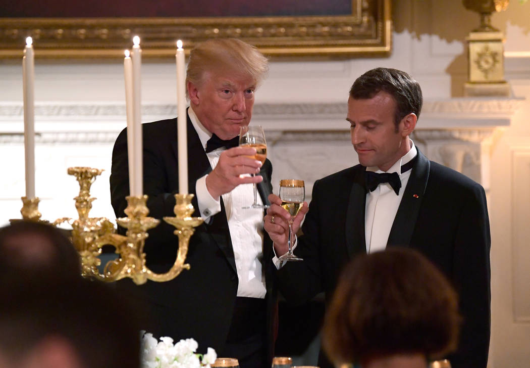 President Donald Trump and French President Emmanuel Macron toast in the State Dining Room during a State Dinner at the White House in Washington, Tuesday, April 24, 2018. (AP Photo/Susan Walsh)