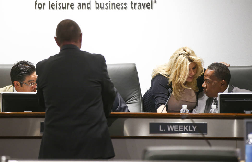 Las Vegas Convention and Visitors Authority board members Michele Fiore, third from left, and Lawrence Weekly talk after a meeting of the LVCVA's audit committee at the Las Vegas Convention Center ...