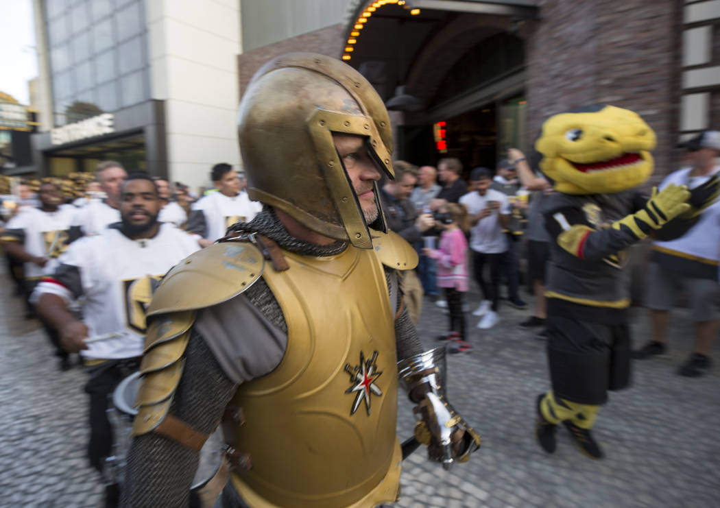 The Vegas Golden Knight and Chance the Golden Gila Monster participate in the March to the Fortress ahead of Game 1 of an NHL hockey first-round playoff series between the Golden Knights and the L ...