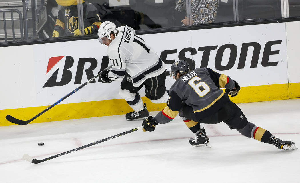 Los Angeles Kings center Anze Kopitar (11) and Golden Knights defenseman Colin Miller (6) view for the puck during the third period of Game 2 of an NHL hockey first-round playoff series between th ...