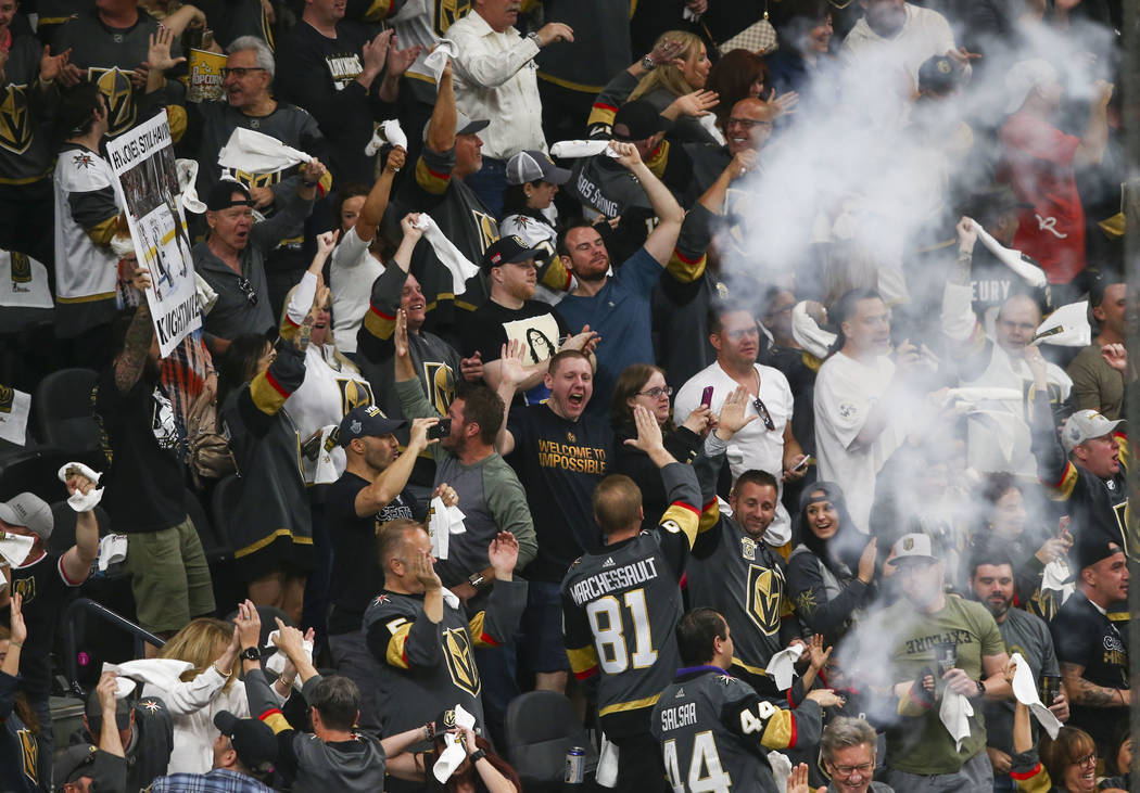 Golden Knights fans celebrate a goal by Golden Knights center Jonathan Marchessault, not pictured, during the first period of Game 1 of an NHL hockey second-round playoff series at T-Mobile Arena ...