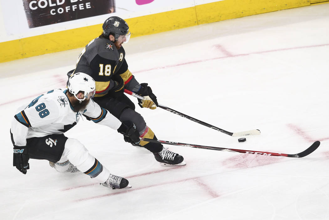 Golden Knights left wing James Neal (18) controls the puck as San Jose Sharks defenseman Brent Burns (88) defends during the second period of Game 1 of an NHL hockey second-round playoff series at ...