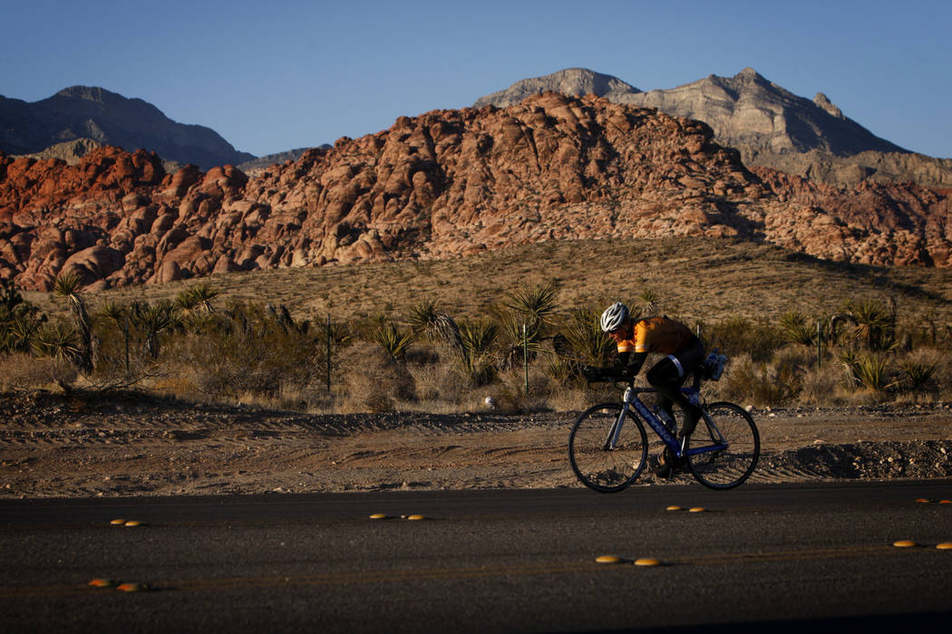 A cyclist rides along State Route 159 in front of Red Rock Canyon National Conservation Area outside Las Vegas in 2011. (Las Vegas Review-Journal)