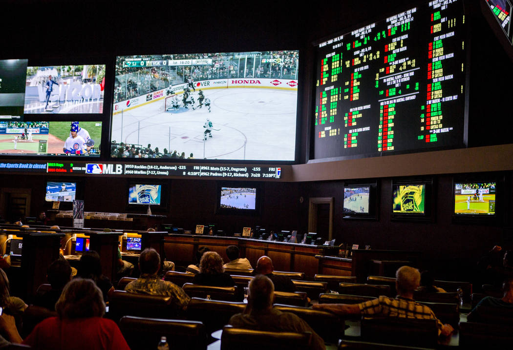 Sports betters watch the Golden Knights play the San Jose Sharks during the second round of the NHL playoffs at the Green Valley Ranch sports book in Henderson on Thursday, April 26, 2018. Patric ...