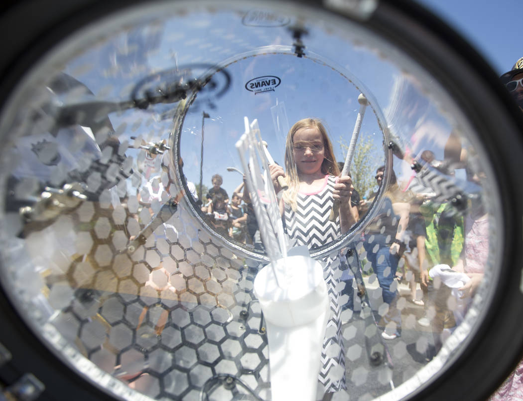 Golden Knights fan Abigail Shearin, 9, beats a drums with a member of the Knight Line outside City National Arena in Las Vegas, Sunday, April 29, 2018, during a send-off event for the team ahead o ...