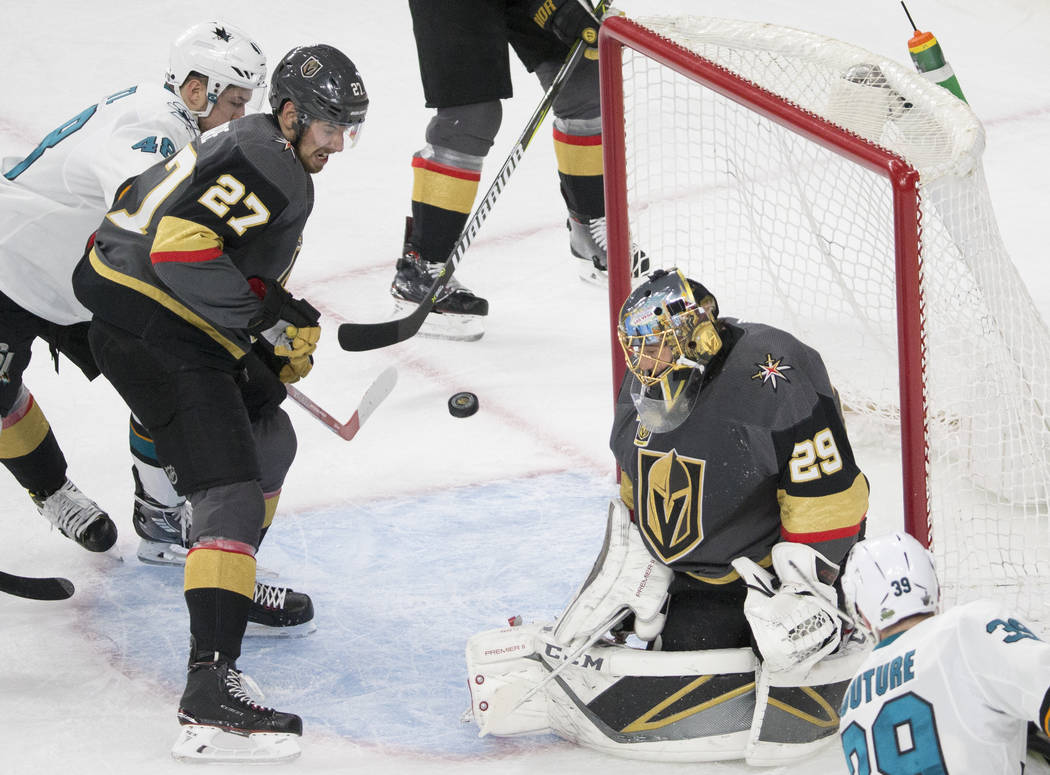 Golden Knights goaltender Marc-Andre Fleury (29) makes a save with the help of defenseman Shea Theodore (27) during game two of their second round playoff series on Saturday, April 28, 2018, at T- ...
