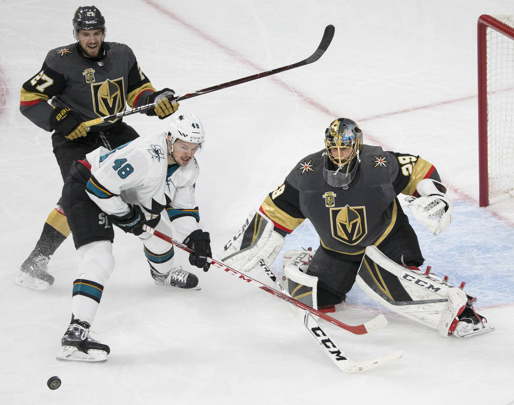 Golden Knights goaltender Marc-Andre Fleury (29) makes a save against San Jose Sharks center Tomas Hertl (48) with the help of defenseman Shea Theodore (27) during game two of their second round p ...