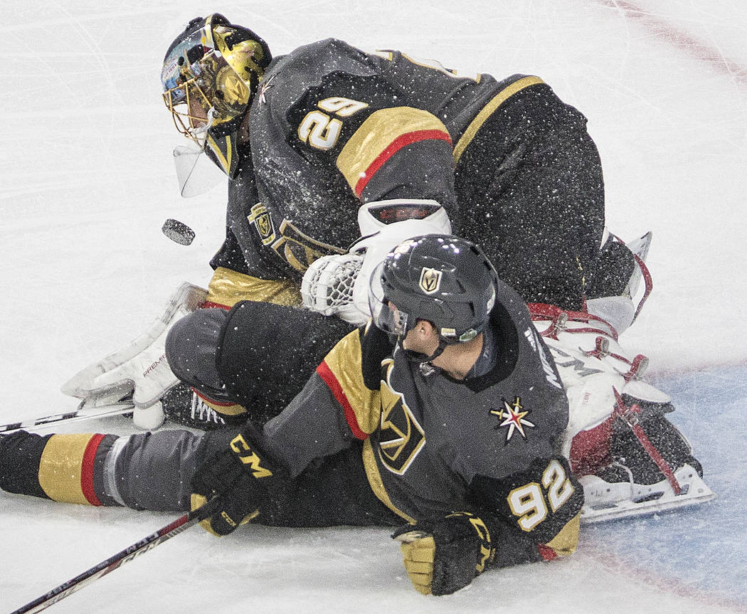 Golden Knights goaltender Marc-Andre Fleury (29) makes a save with help from center Tomas Nosek (92) during game two of their second round playoff series on Saturday, April 28, 2018, at T-Mobile A ...