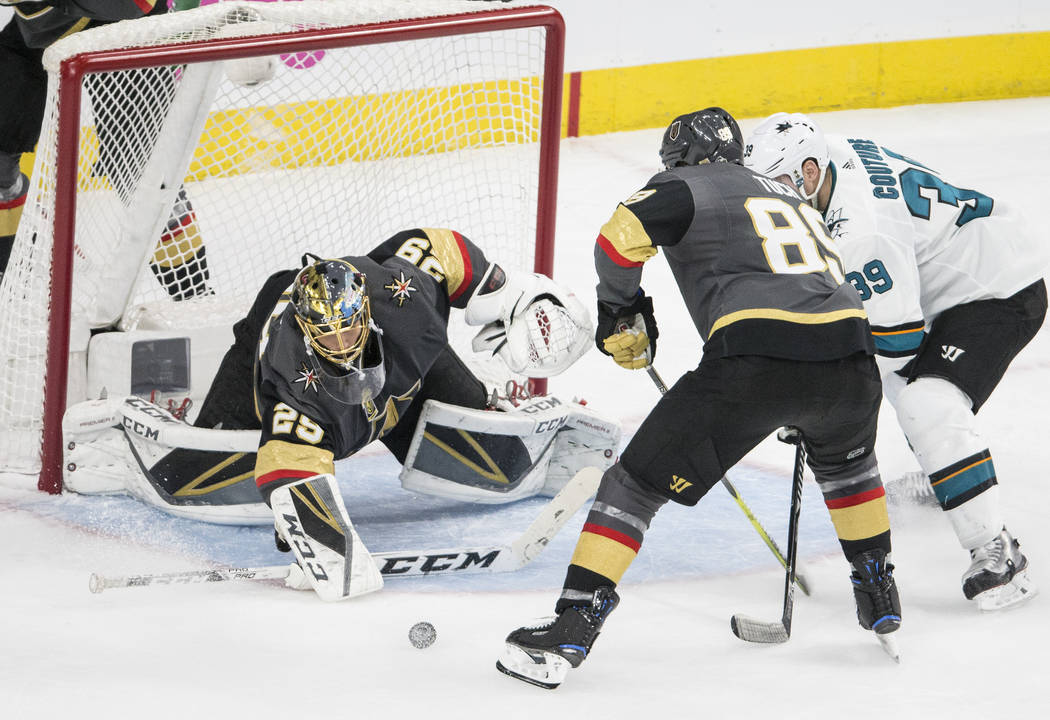 Golden Knights goaltender Marc-Andre Fleury (29) makes a save against San Jose Sharks center Logan Couture (39) with the help of right wing Alex Tuch (89) during game two of their second round pl ...