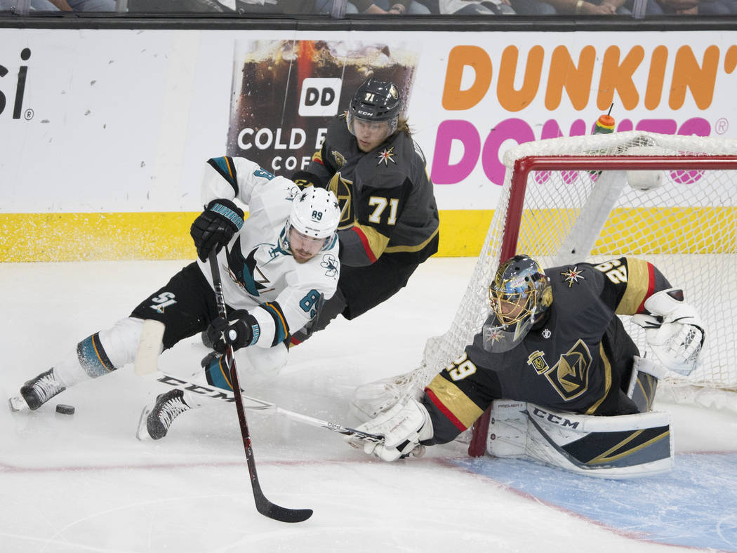 Golden Knights goaltender Marc-Andre Fleury (29) makes a save against San Jose Sharks left wing Mikkel Boedker (89) with the help of center William Karlsson (71) in overtime during game two of the ...