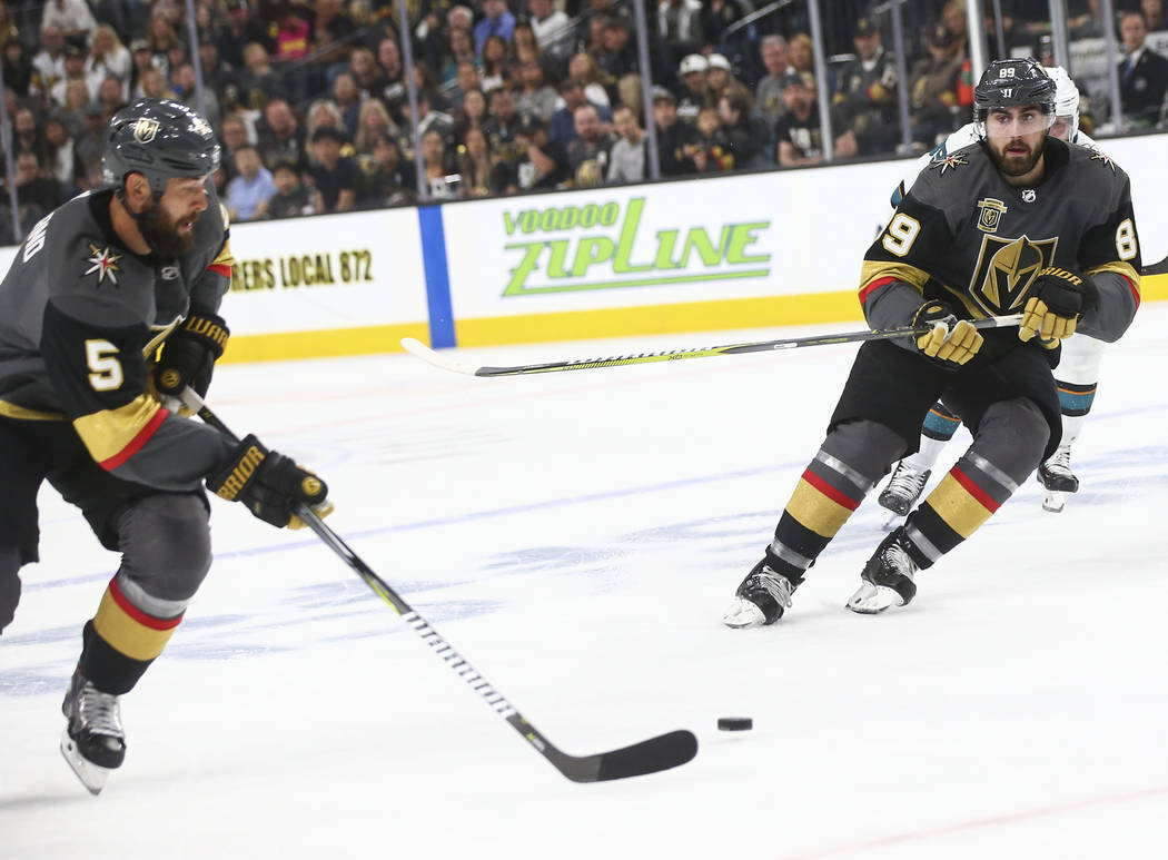Golden Knights right wing Alex Tuch (89) passes the puck to defenseman Deryk Engelland (5) during the first period of Game 2 of an NHL hockey second-round playoff series against the San Jose Shark ...