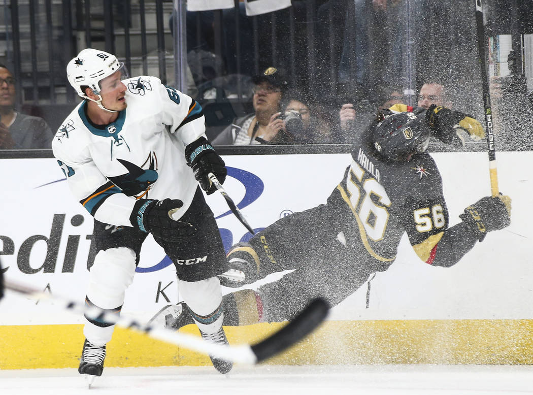 Golden Knights left wing Erik Haula (56) gets tripped up by San Jose Sharks defenseman Justin Braun (61) during the first period of Game 2 of an NHL hockey second-round playoff series at T-Mobile ...